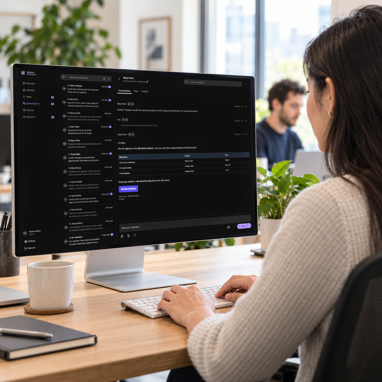 A professional using Vakara’s customer conversation workspace on a large office monitor